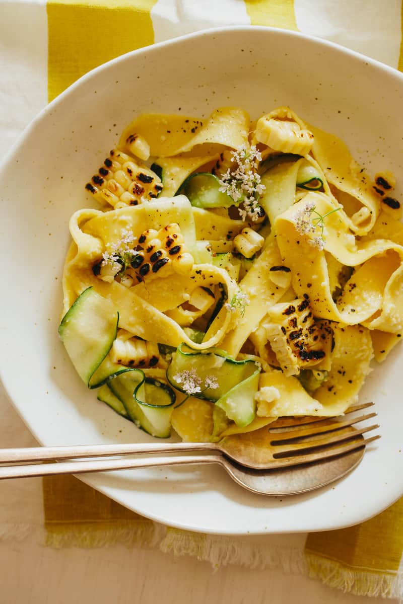 A close up of a bowl of sweet corn pesto with pappardelle and zucchini noodles.