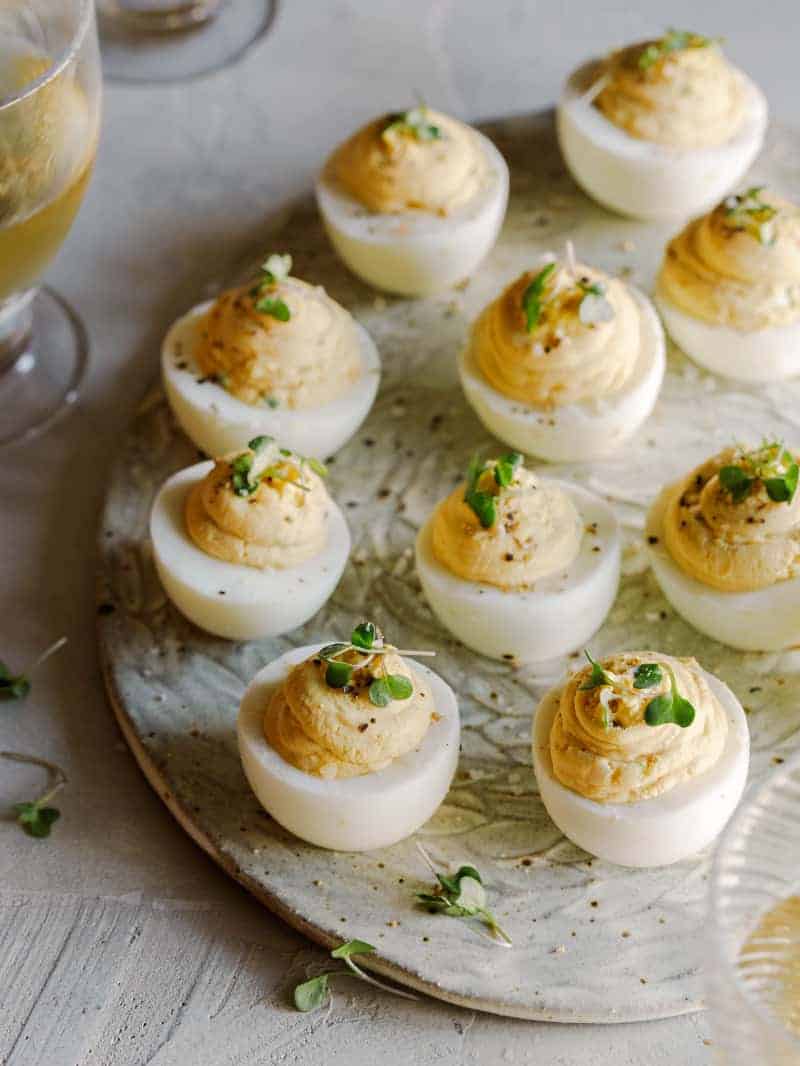 Caramelized onion and herb deviled eggs on a platter.