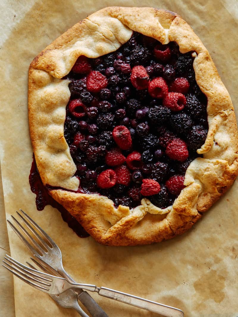 A mixed berry galette with forks.