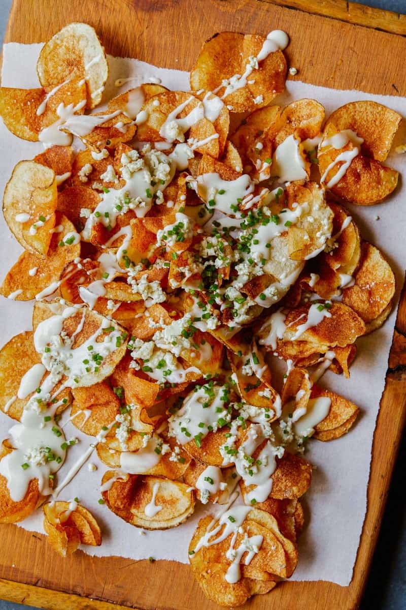 A close up of homemade potato chips with gorgonzola cheese sauce.