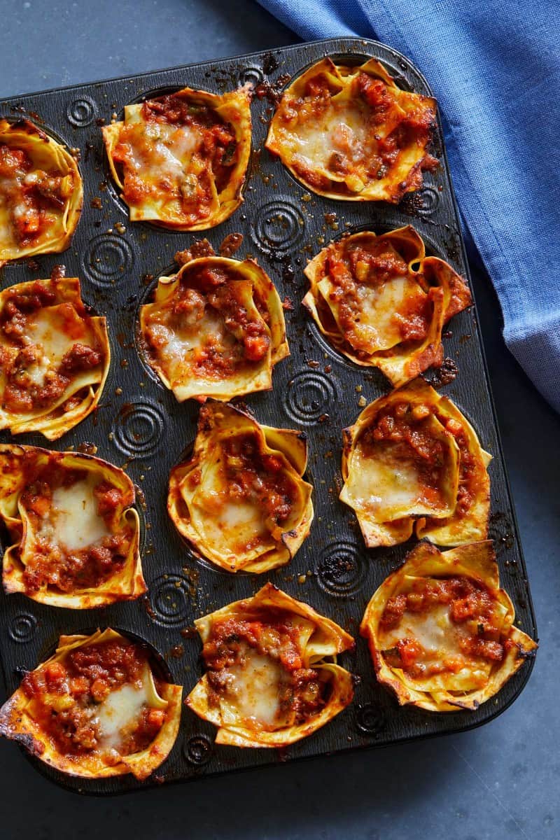 Baked off lasagna cups in a muffin tin.