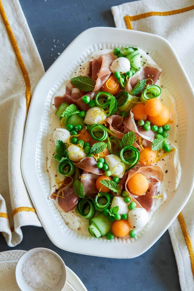 A close up of a fresh summer appetizer platter with napkins.