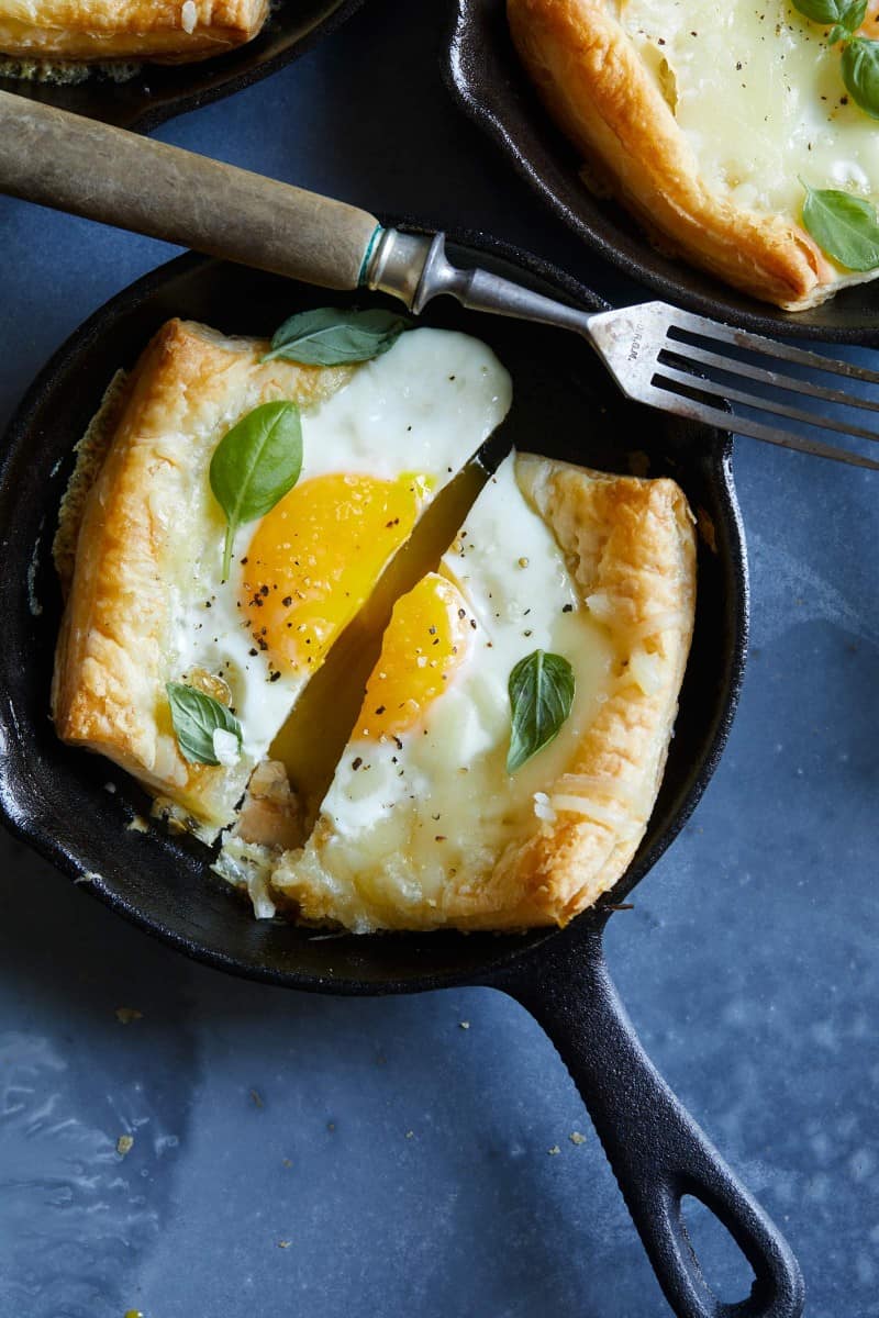 A close up of simple egg and cheese tartlets in an individual skillet with a fork.
