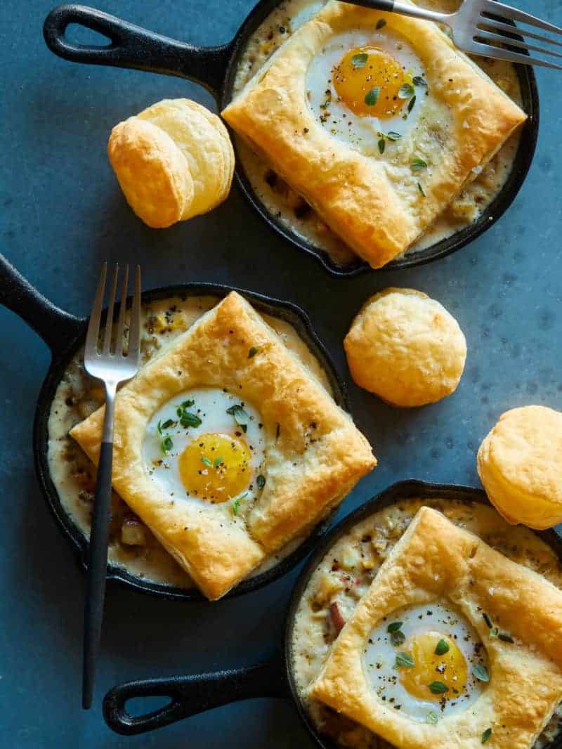 Individual breakfast pot pies with a fork.