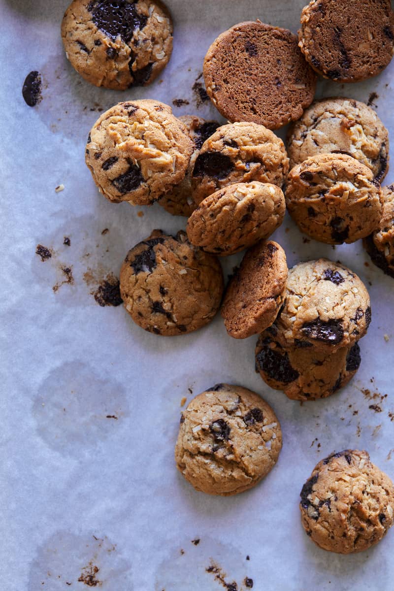 A close up of chai, chocolate chip, and coconut cookies.