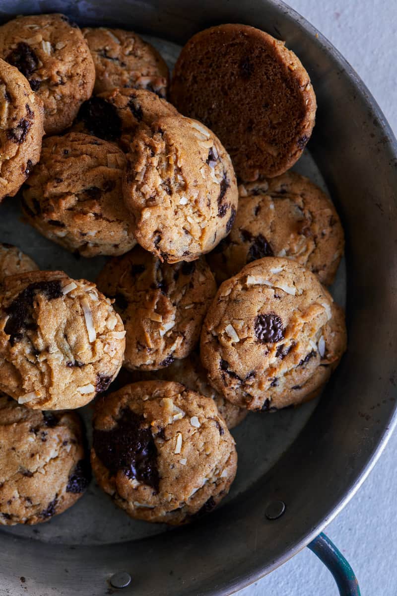 A close up of chai, chocolate chip, and coconut cookies.