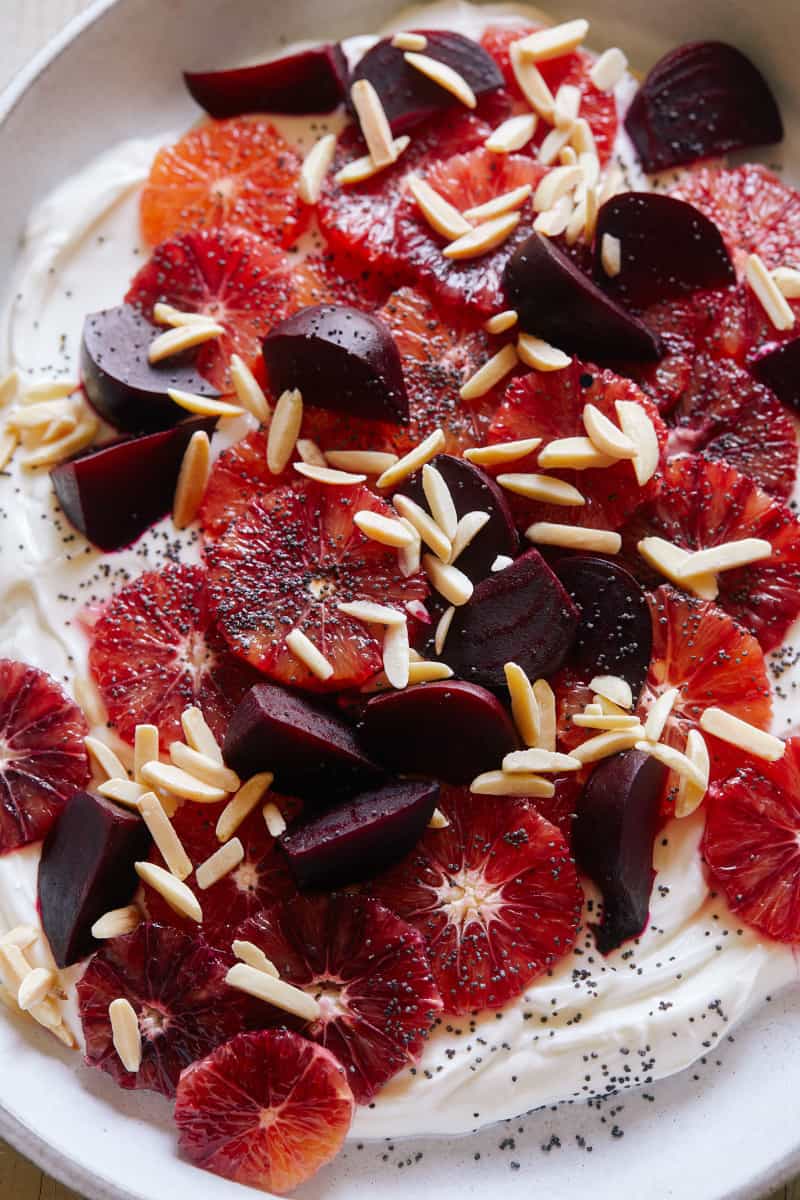 A close up of blood orange and beet salad over honeyed yogurt.