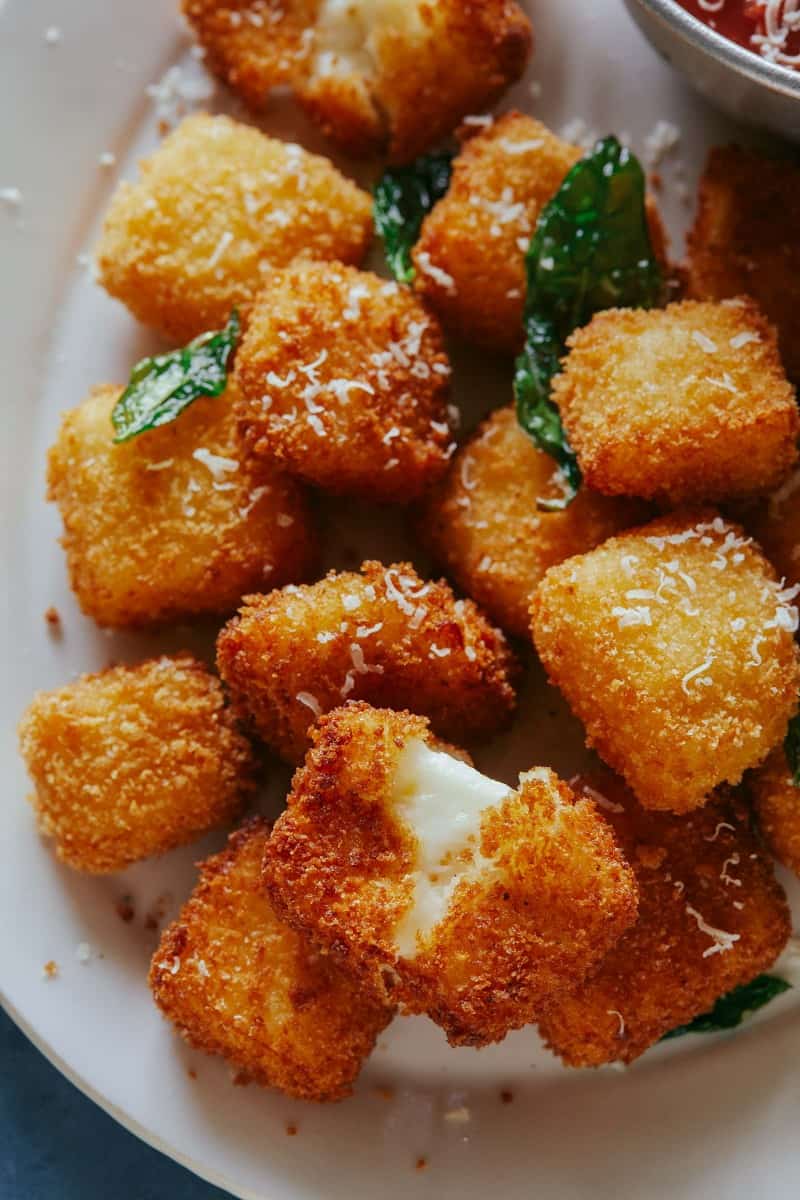 A close up of hallumi nuggets with marinara sauce.