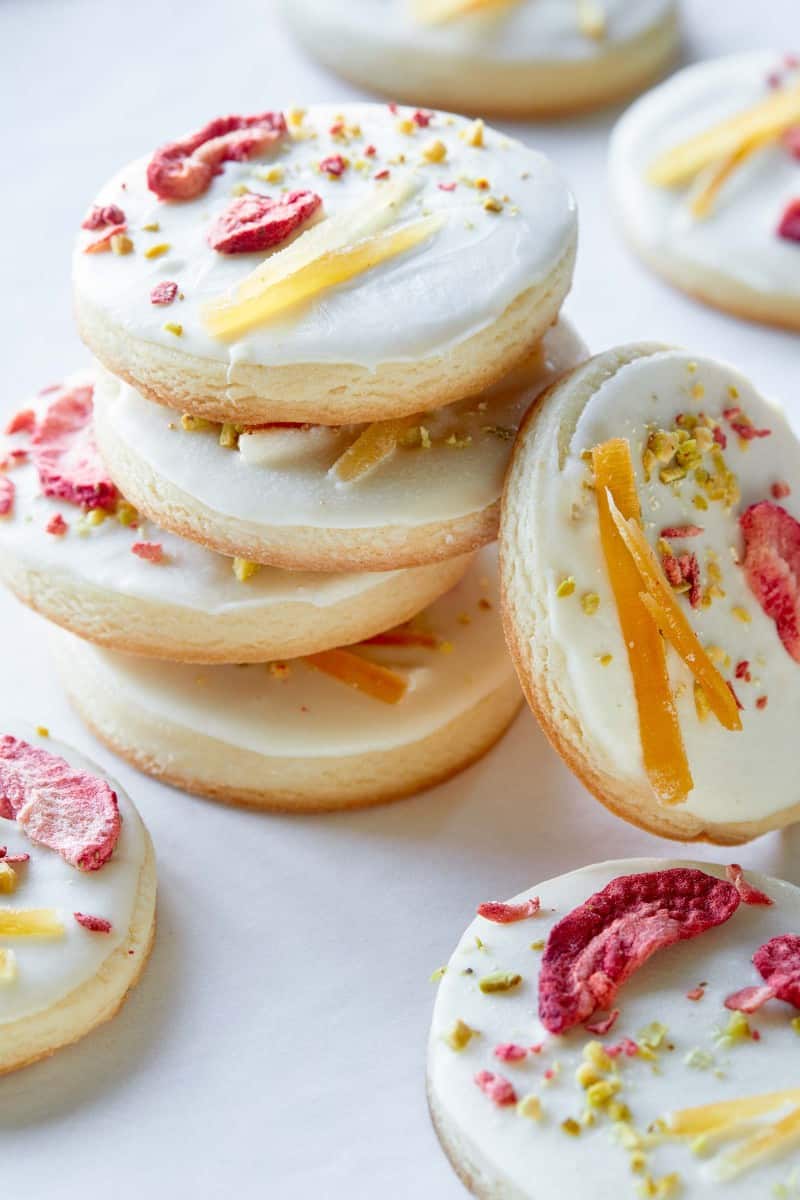 A close up of stacked white chocolate dipped butter cookies.