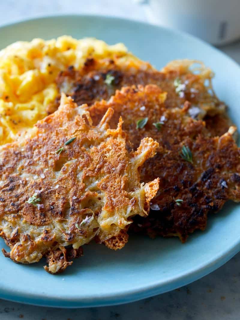 A close up of a plate of crispy cheese hash browns.