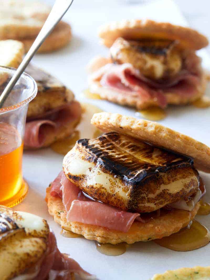 A close up of savory smores with honey.