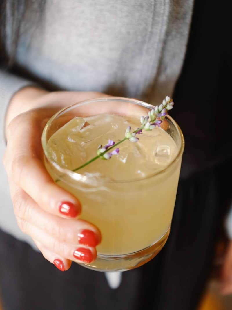 A close up of a lavender bees knees cocktail.