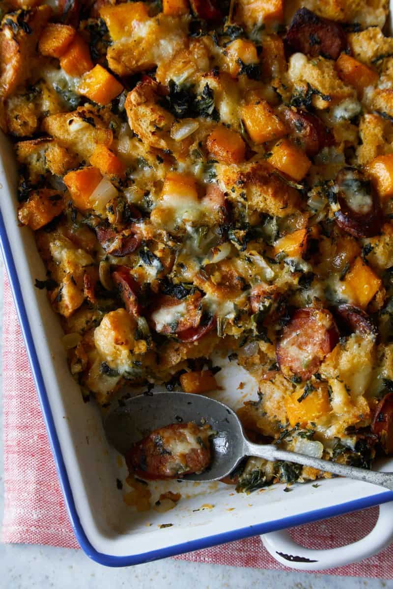 A close up of butternut squash sage stuffing with a spoon.