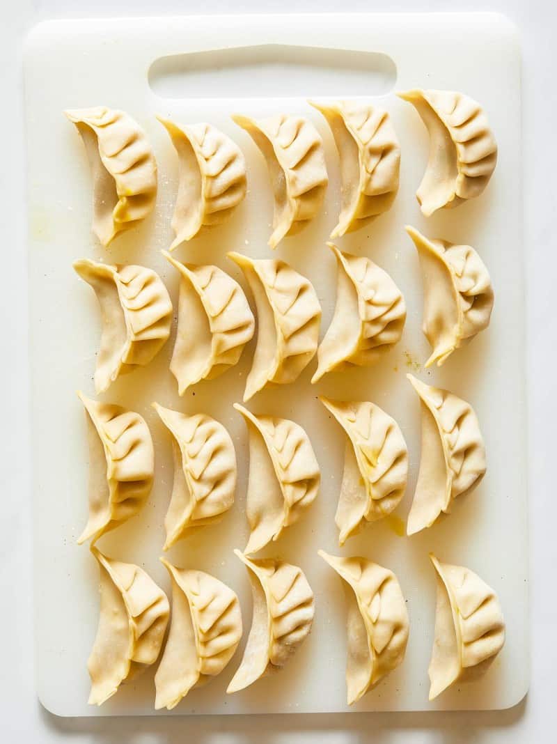 Uncooked ginger chicken pot stickers.