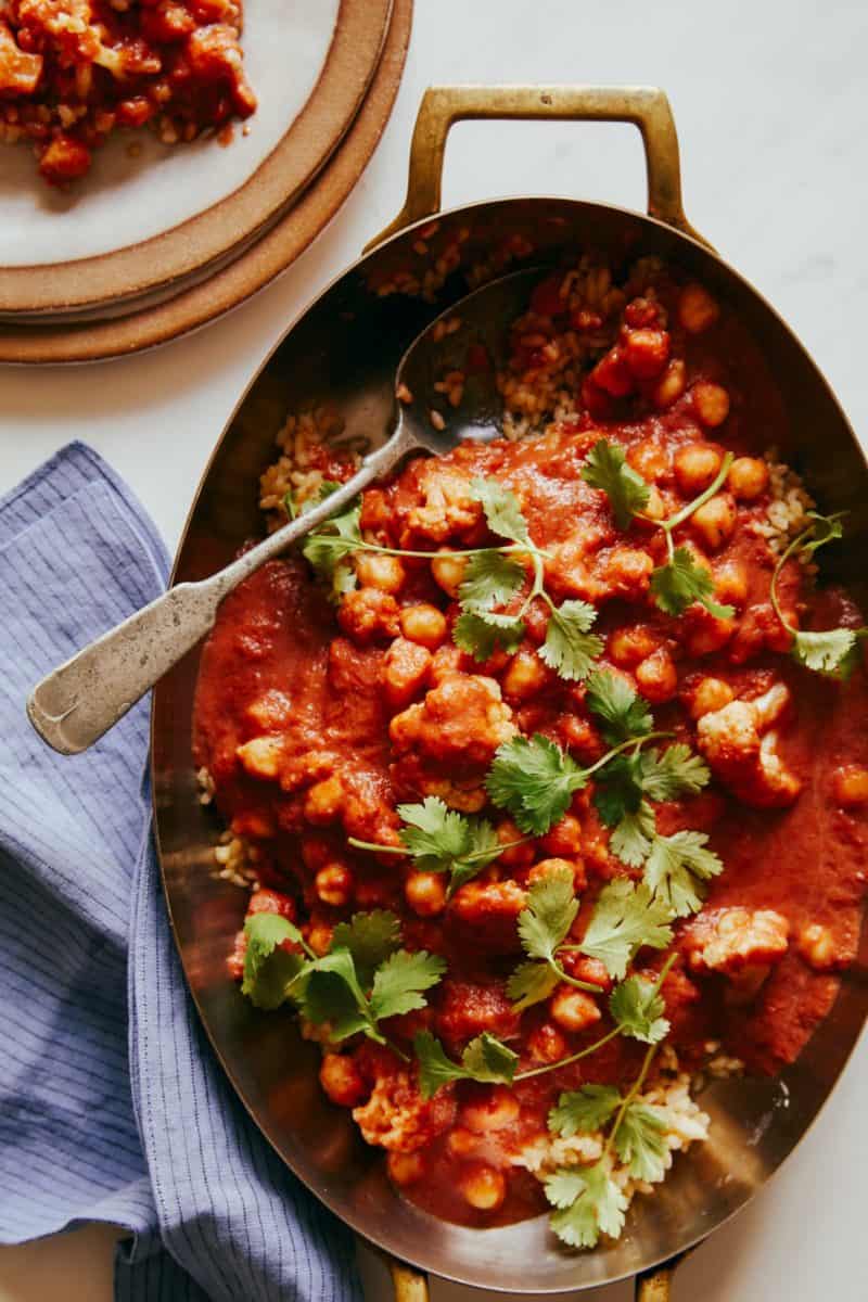 Spicy vegan chickpea and cauliflower curry with a spoon.