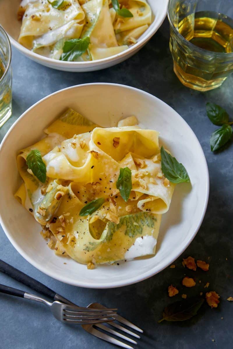 A bowl of herb laced pappardelle in walnut cream sauce.