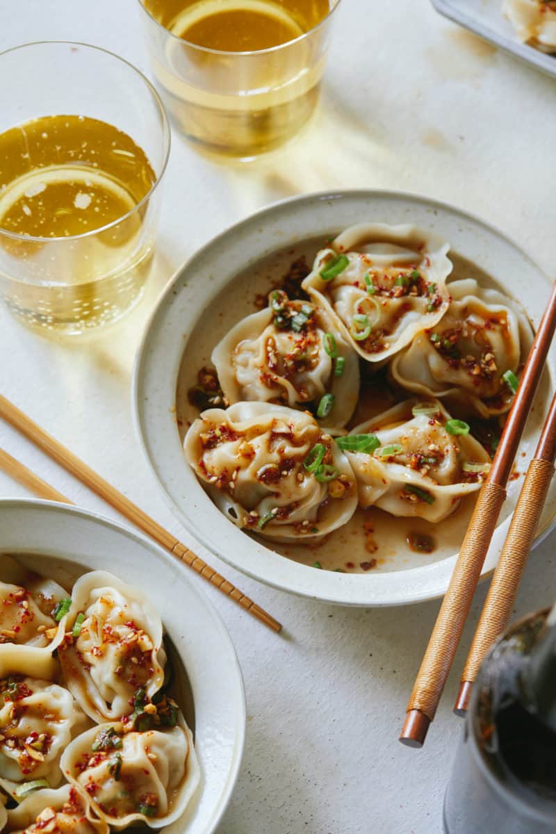 Bowls of pork and shrimp dumplings with chopsticks.