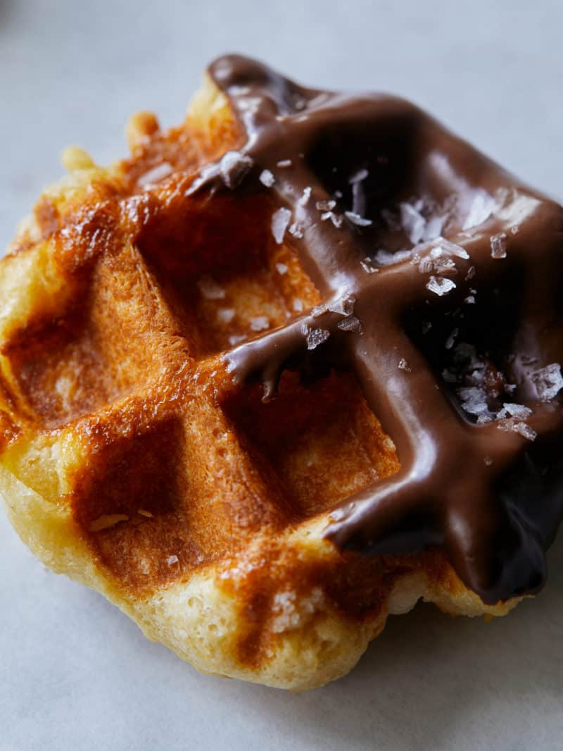 A close up of a salted chocolate dipped liege waffle.