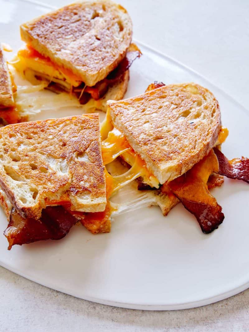 Extra cheesy breakfast grilled cheese sandwiches cut in half.