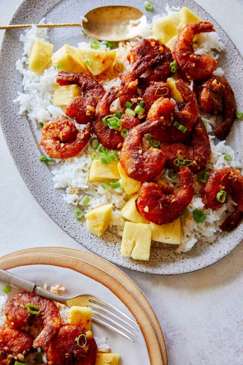 A close up of Hawaiian style crispy garlic butter shrimp over white rice.