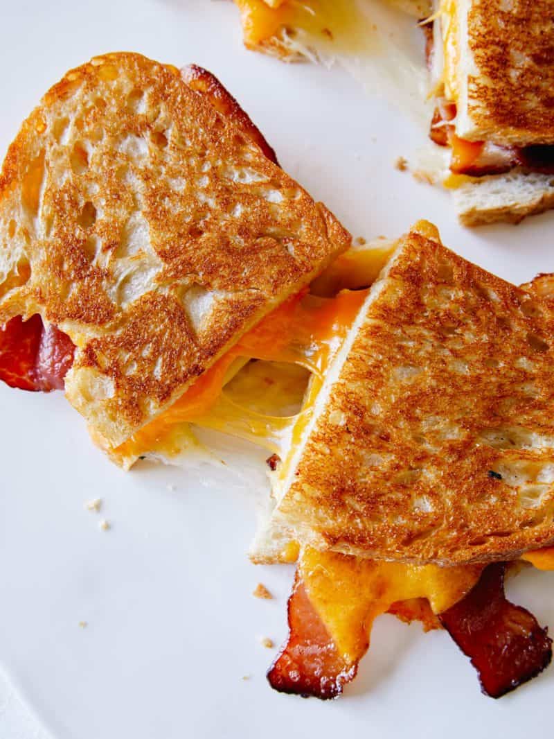 Extra cheesy breakfast grilled cheese sandwiches cut in half.