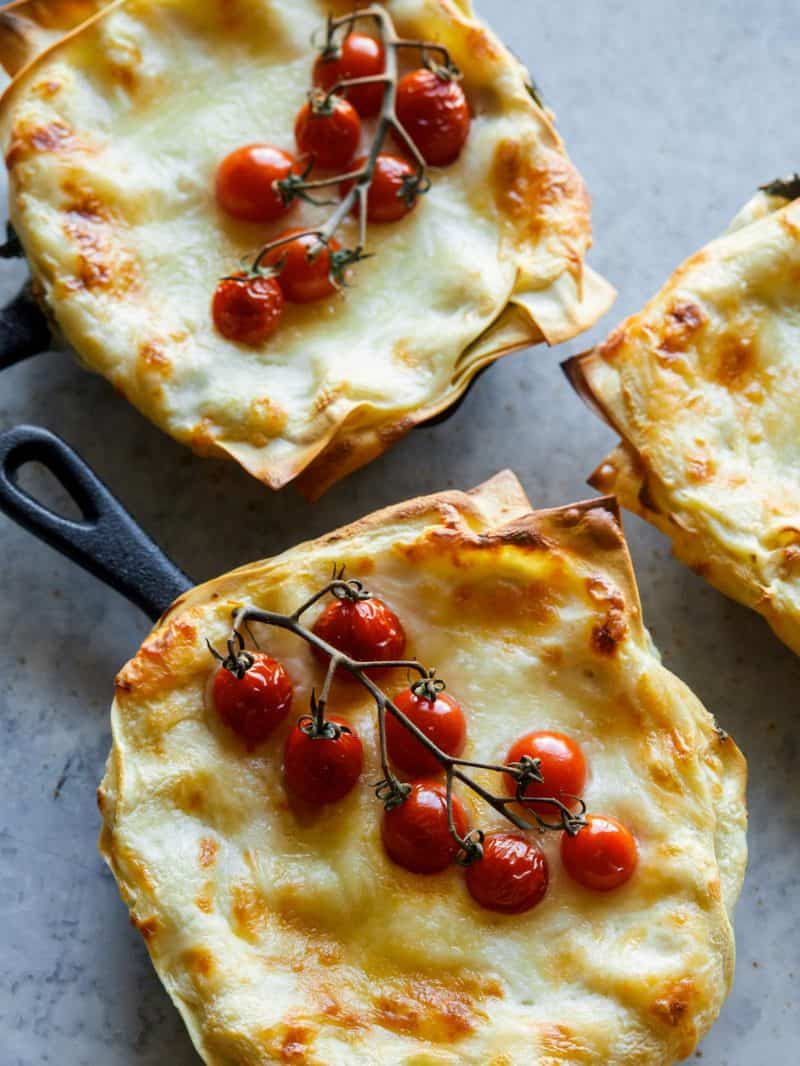 Individual creamy turkey and kale skillet lasagnes.