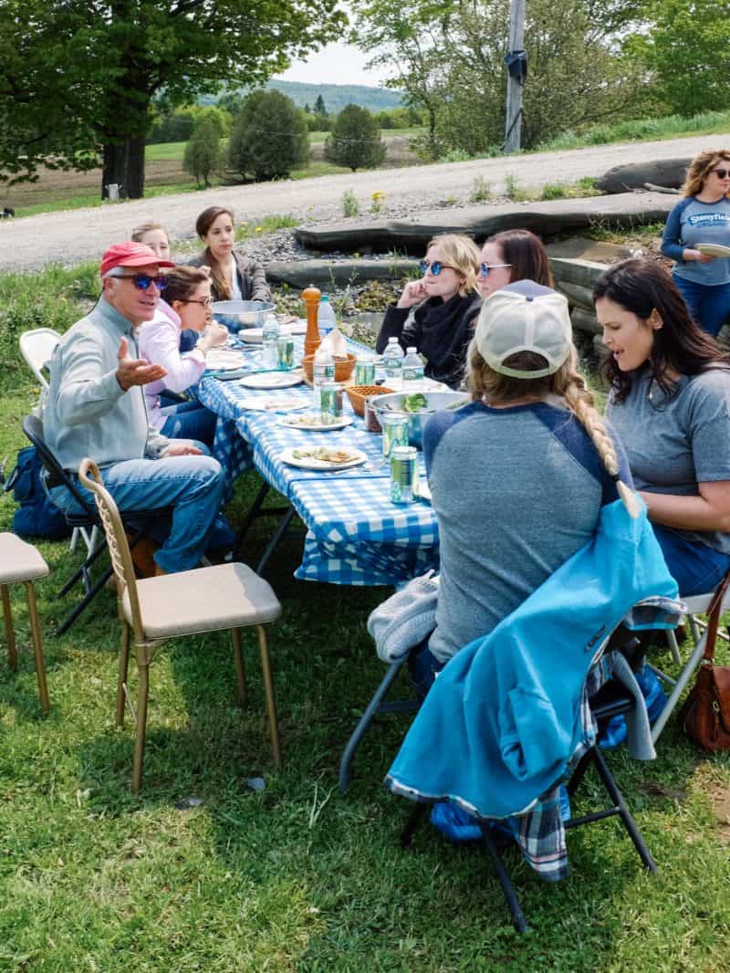 A group of people sitting at a picnic table.