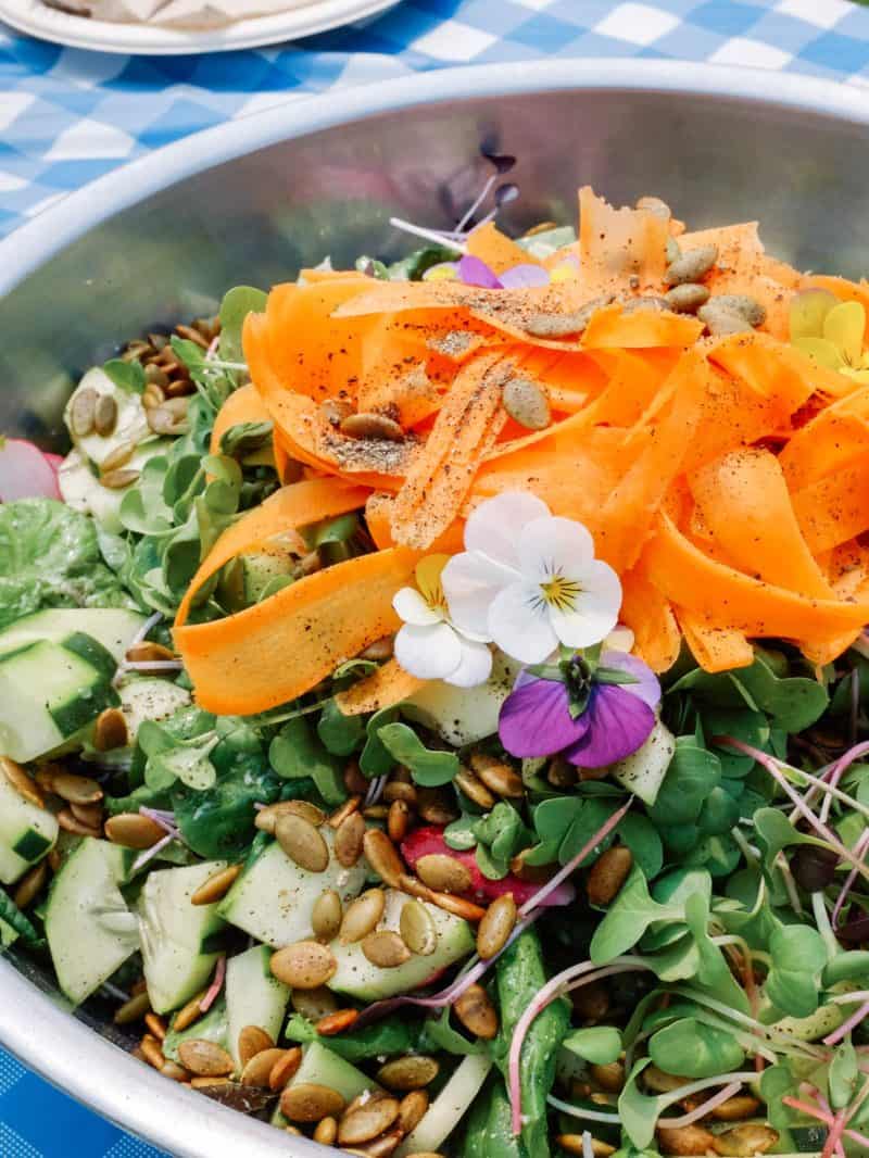 A close up of a summer salad with green goddess dressing.