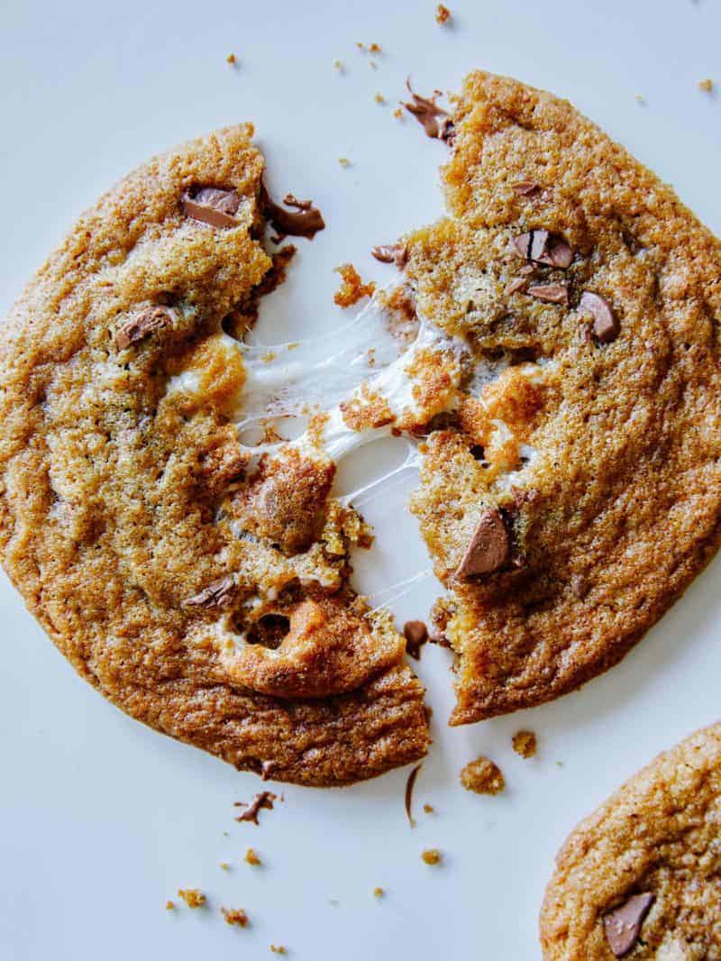 A close up of a marshmallow stuffed S\'more cookie broken in half.