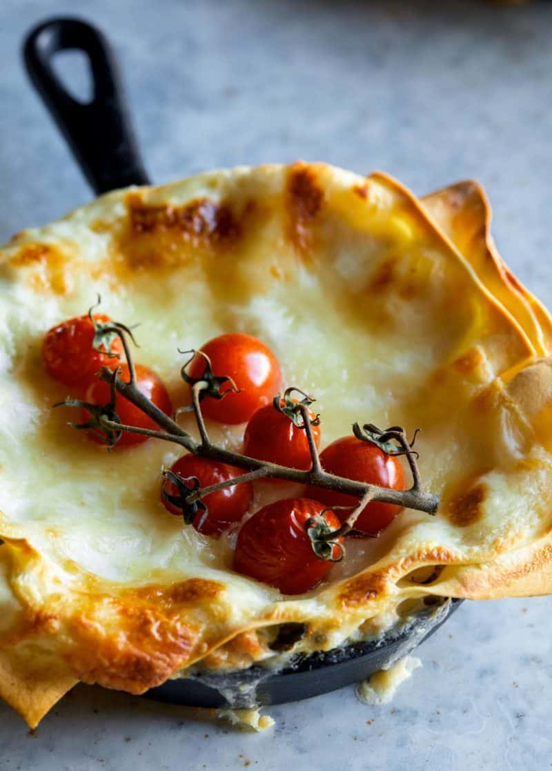 A close up of an individual creamy turkey and kale skillet lasagnes.