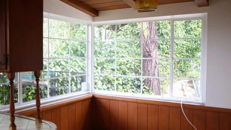 A corner of a room with a large windows.