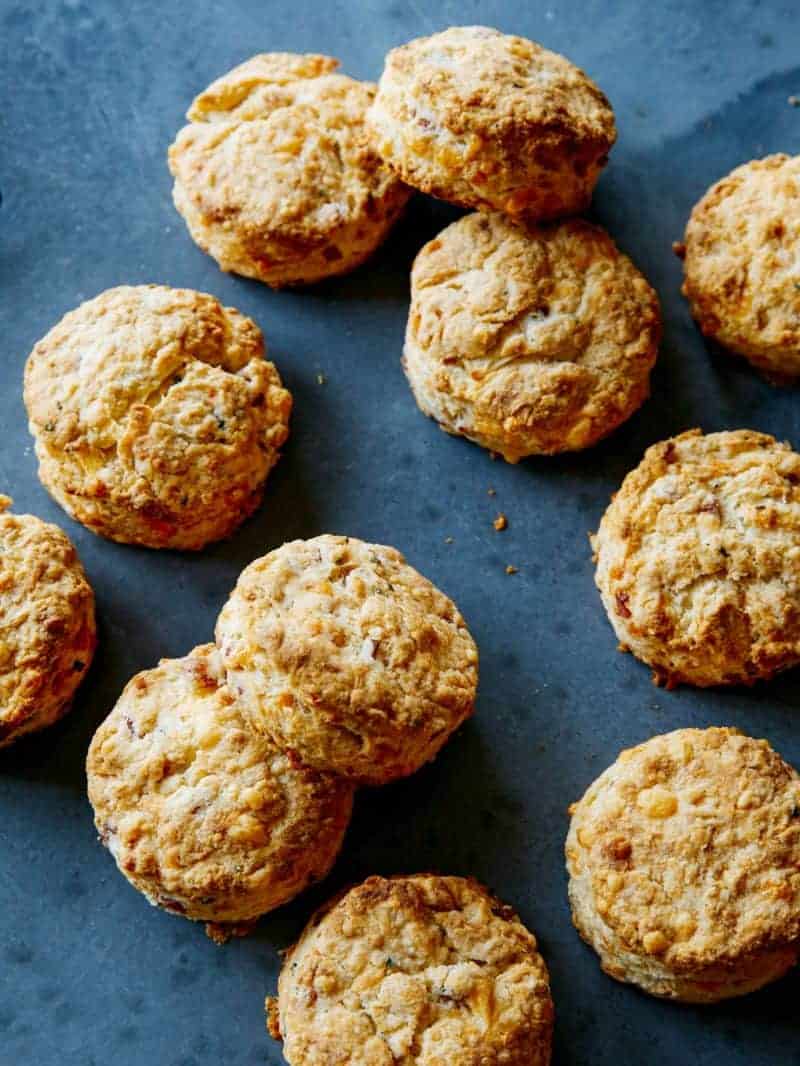 Ham and cheese buttermilk biscuits on a blue background.