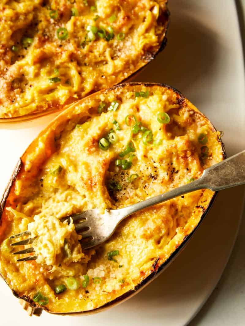 Vegan baked alfredo spaghetti squash with a fork.