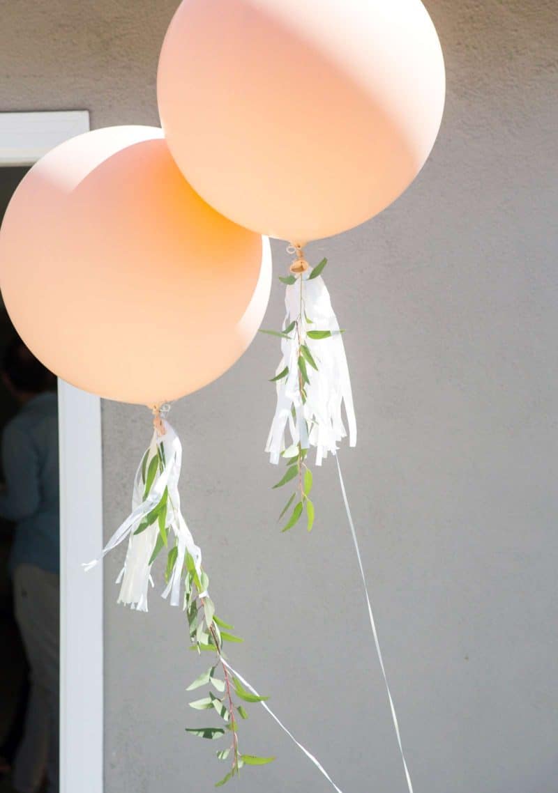 Two oversized balloons with hassle and greenery garland.