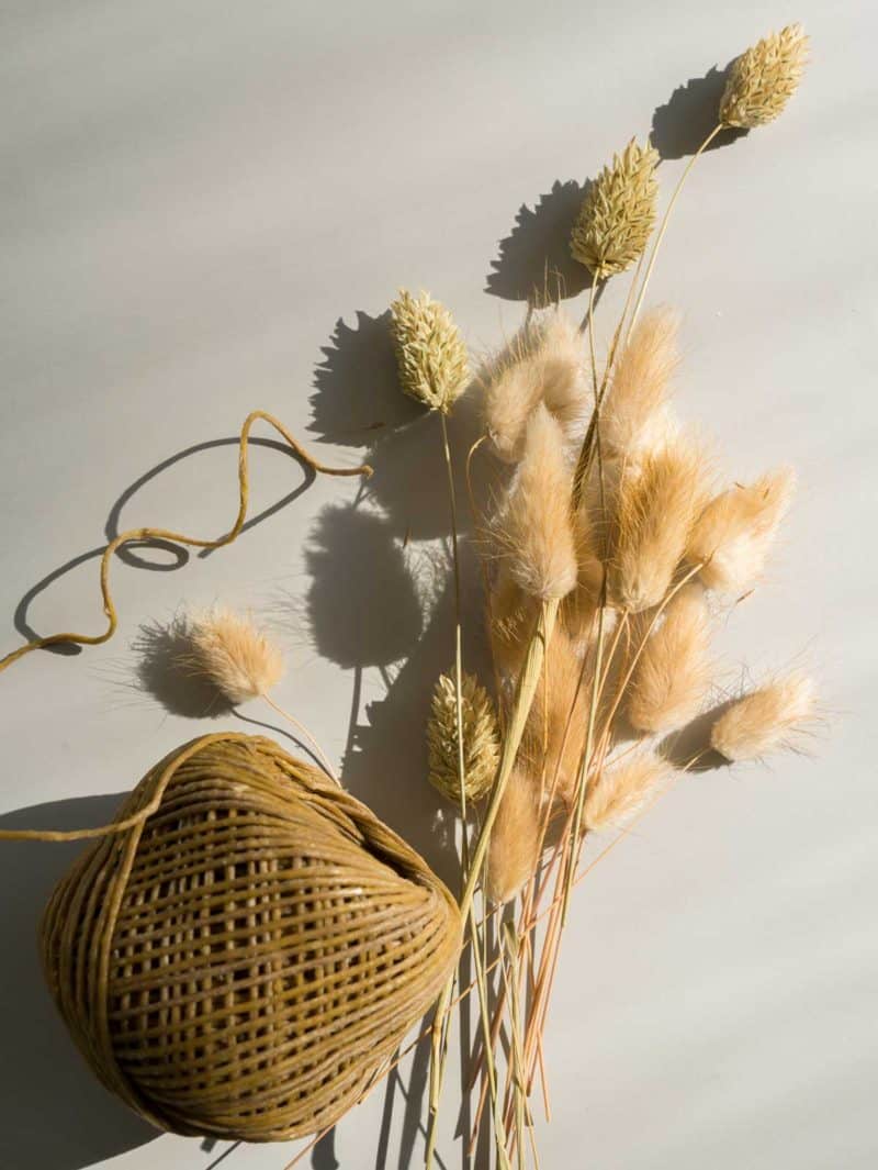 A ball of hemp string with dried rabbit tails and dried grasses.