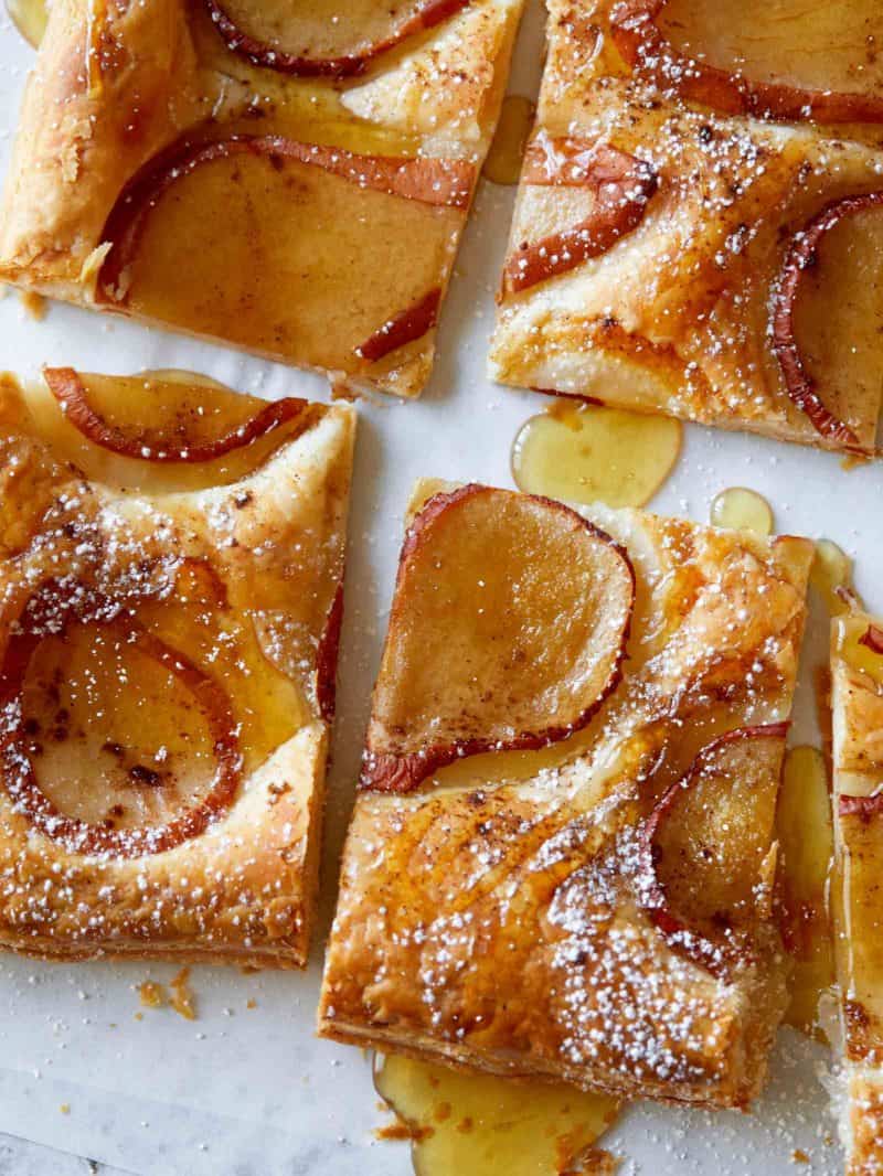 A close up of sliced caramelized pear tart.