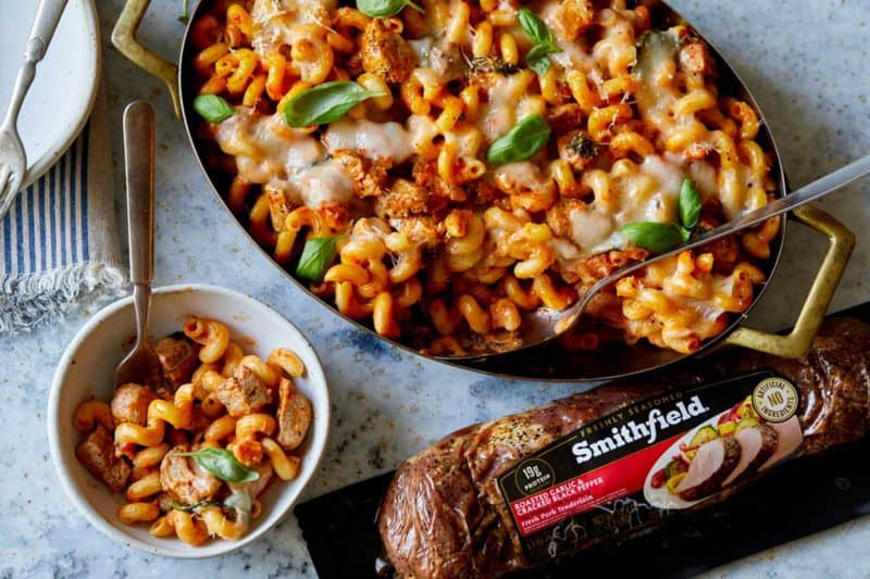 Pan of creamy baked pork pasta with Smithfield pork package.