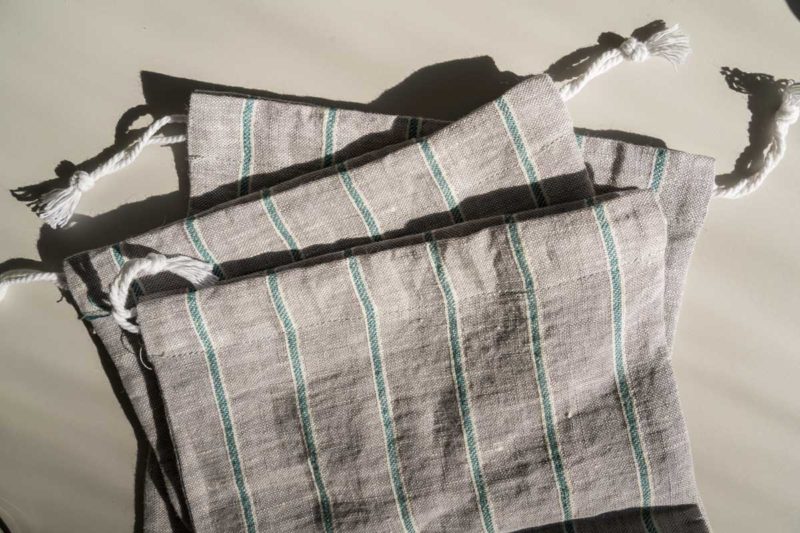 Close up of gray and green striped reusable produce bags.