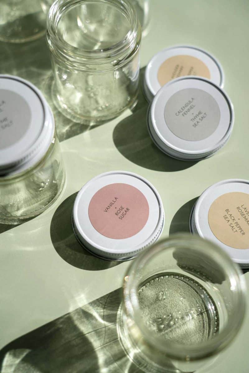 A close up of jars and lids with printed labels.