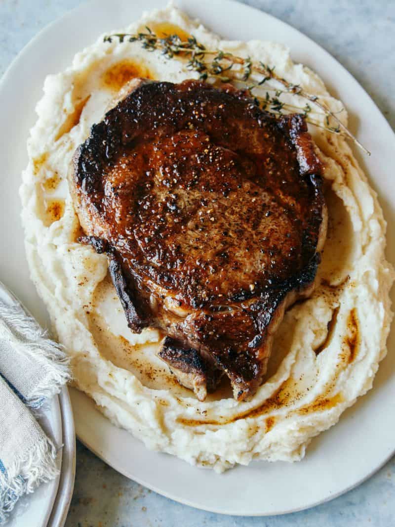 Seared ribeye over brown butter mashed potatoes.