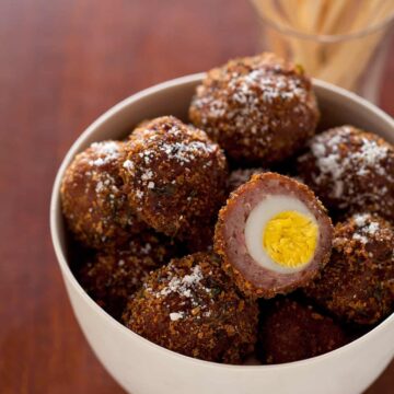 Hard boiled quail egg wrapped in sausage, coated in bread crumbs, then fried.