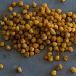 A close up of a pile of fried curry chickpeas.