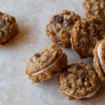 A close up of oatmeal chocolate chip sandwich cookies.