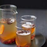 A recipe for Spiced White Wine Sangria with cinnamon sticks, star anise, and tangerines.