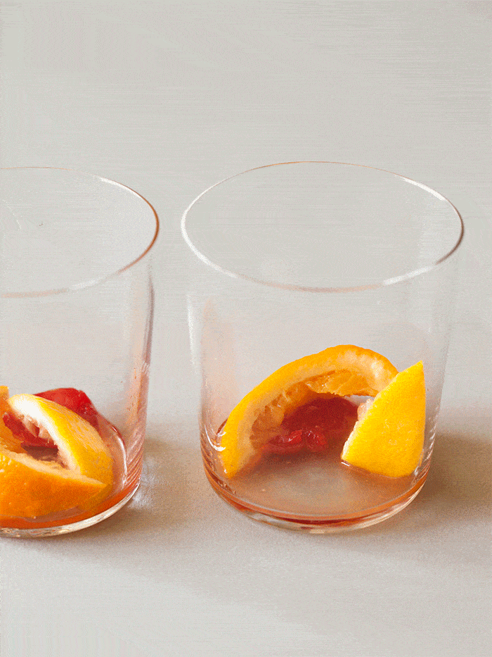 Winter spiced old fashioned being made in a glass gif.