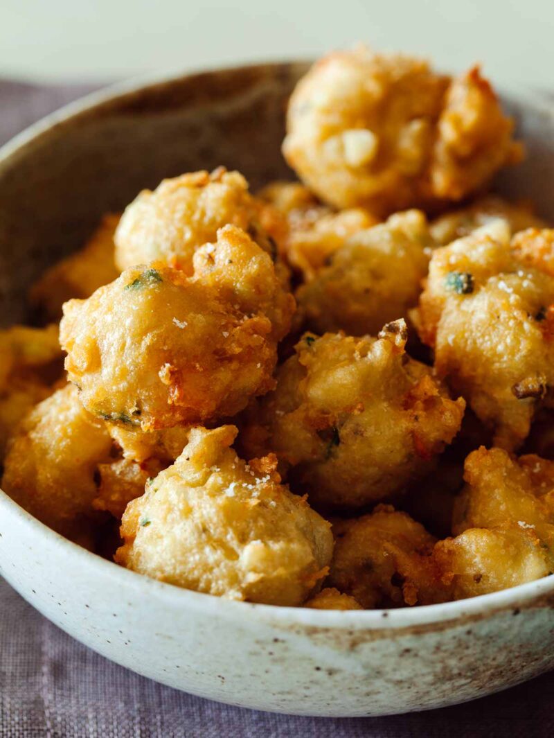 A close up of shrimp fritters in a bowl.