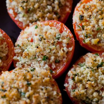 A close up of herb and panko crusted baked tomatoes.