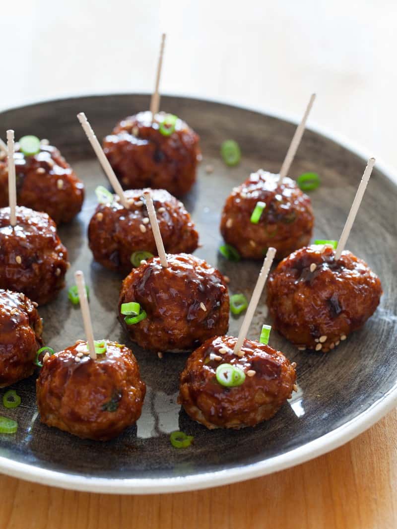 Korean style Cocktail Meatballs topped with green onions.