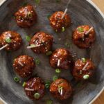 Cocktail meatballs with a Korean chili sauce, topped with green onions.