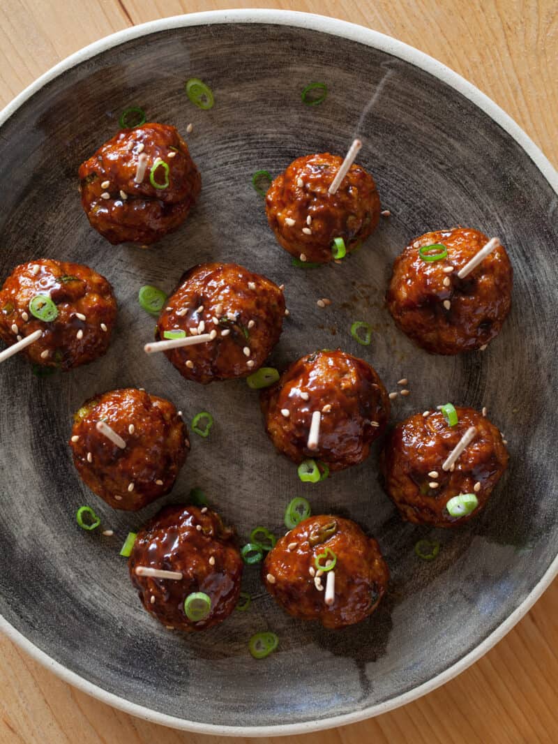 Cocktail meatballs with a Korean chili sauce, topped with green onions.